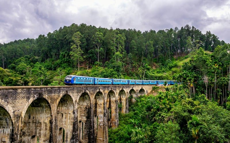 Blue train crossing the Nine Arches Bridge in Sri Lanka